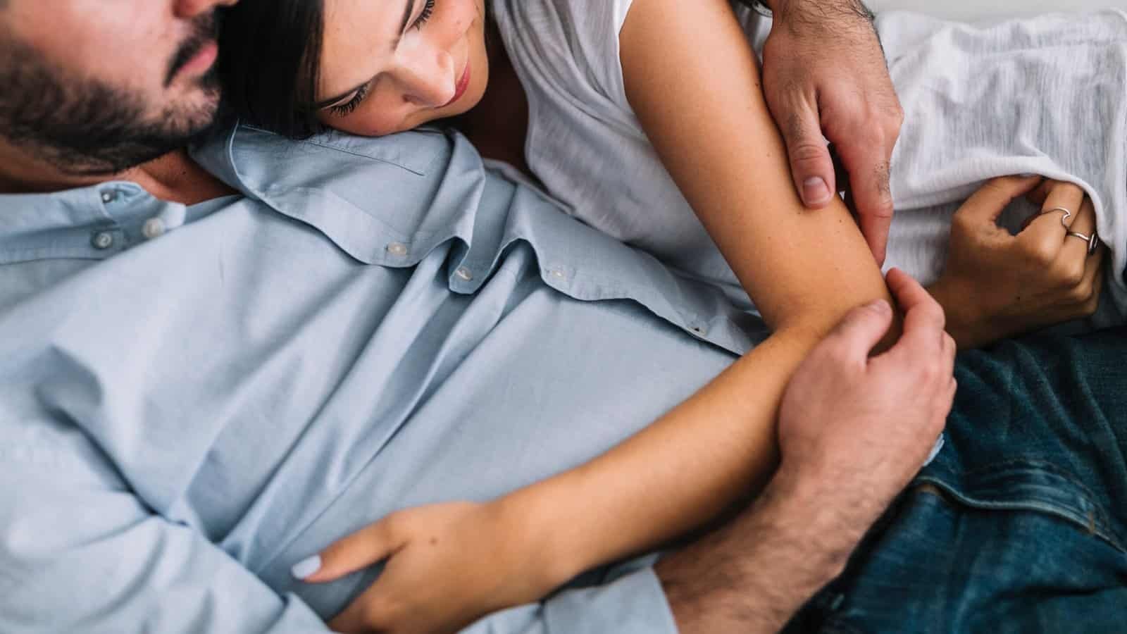 woman laying with her boyfriend, snuggling